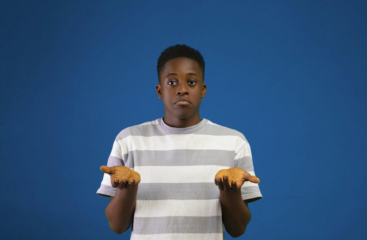 A person shrugging with both hands raised