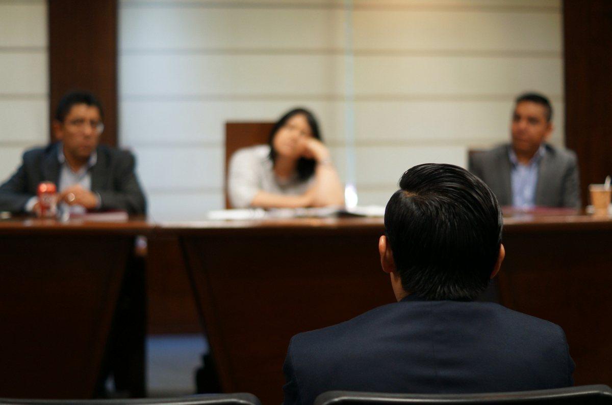 Attorneys meeting with a client across a conference table